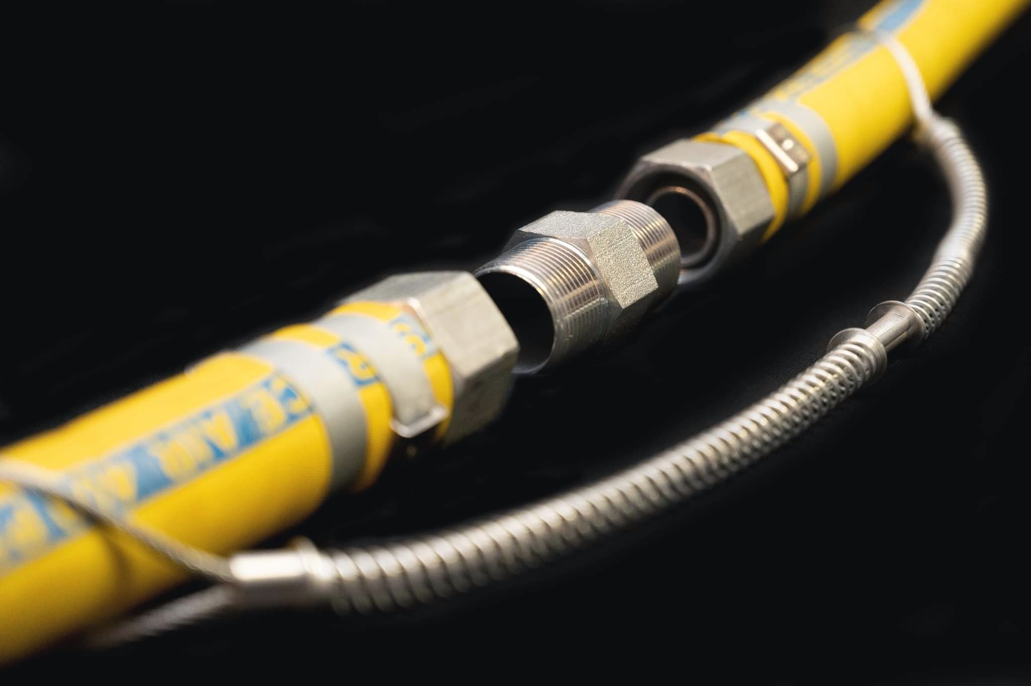 Close-up of the Hexa Hex Nipple connection on a yellow hose assembly