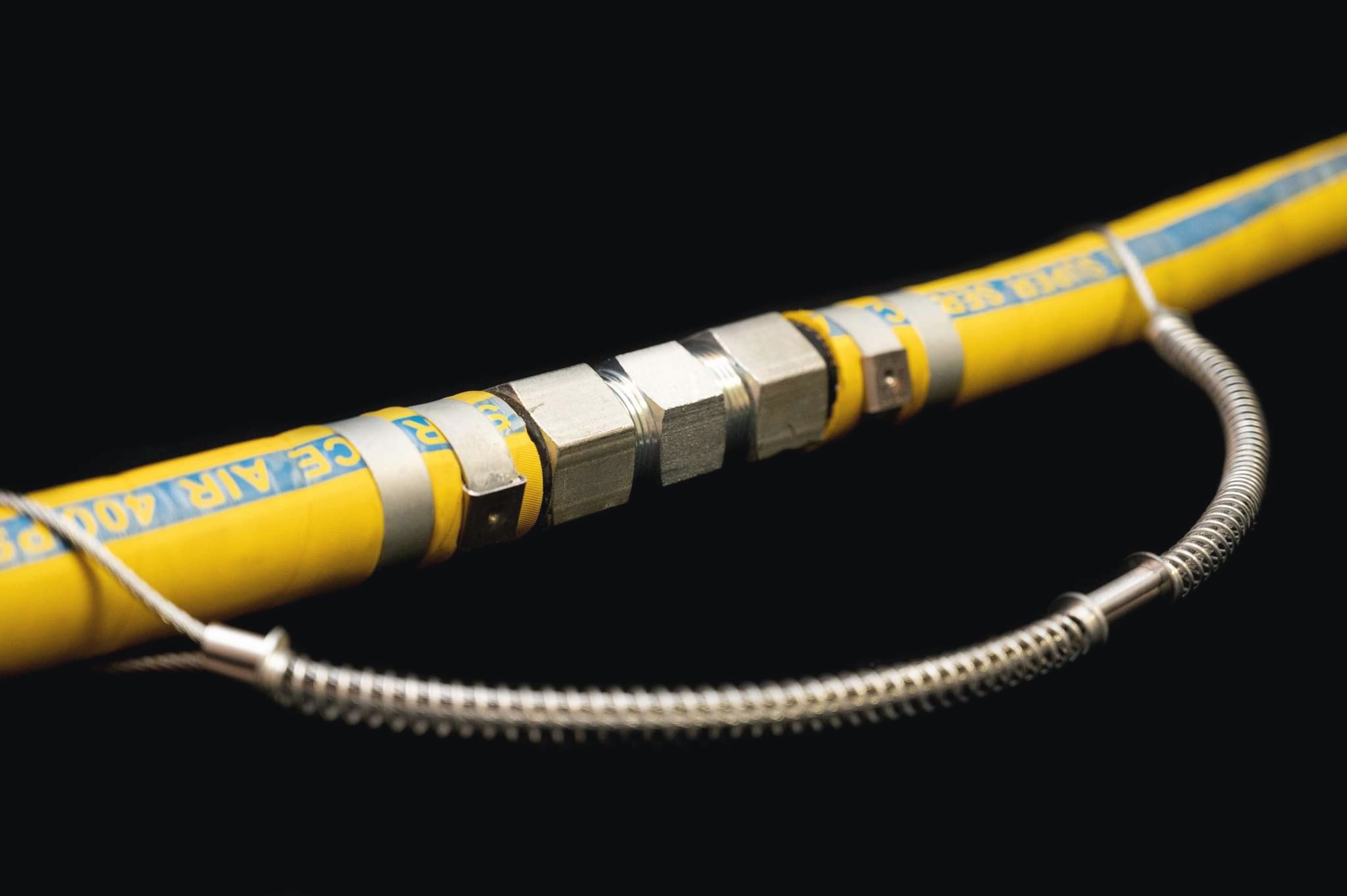 Yellow industrial hose run fitted with the Hexa Hex Nipple