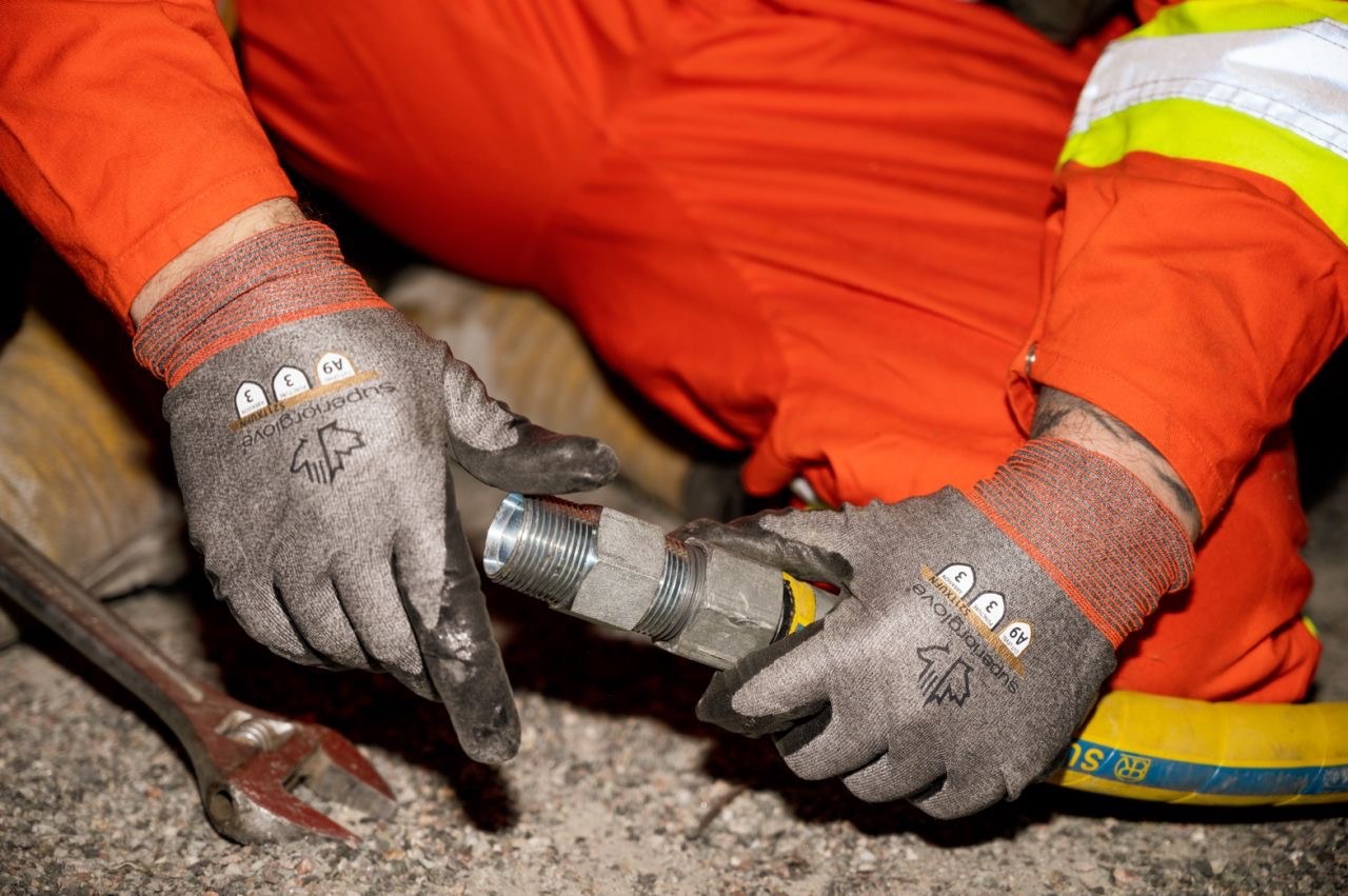 Technician in high visibility clothing handling the Hexa Hex Nipple underground