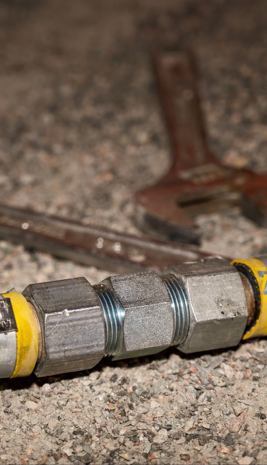 Hexa Hex Nipple connection on a yellow hose resting on rock